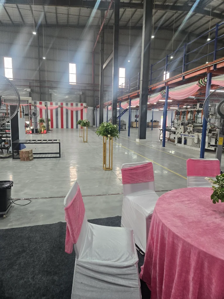 Grand hall setup with pink chair sashes and floral stands